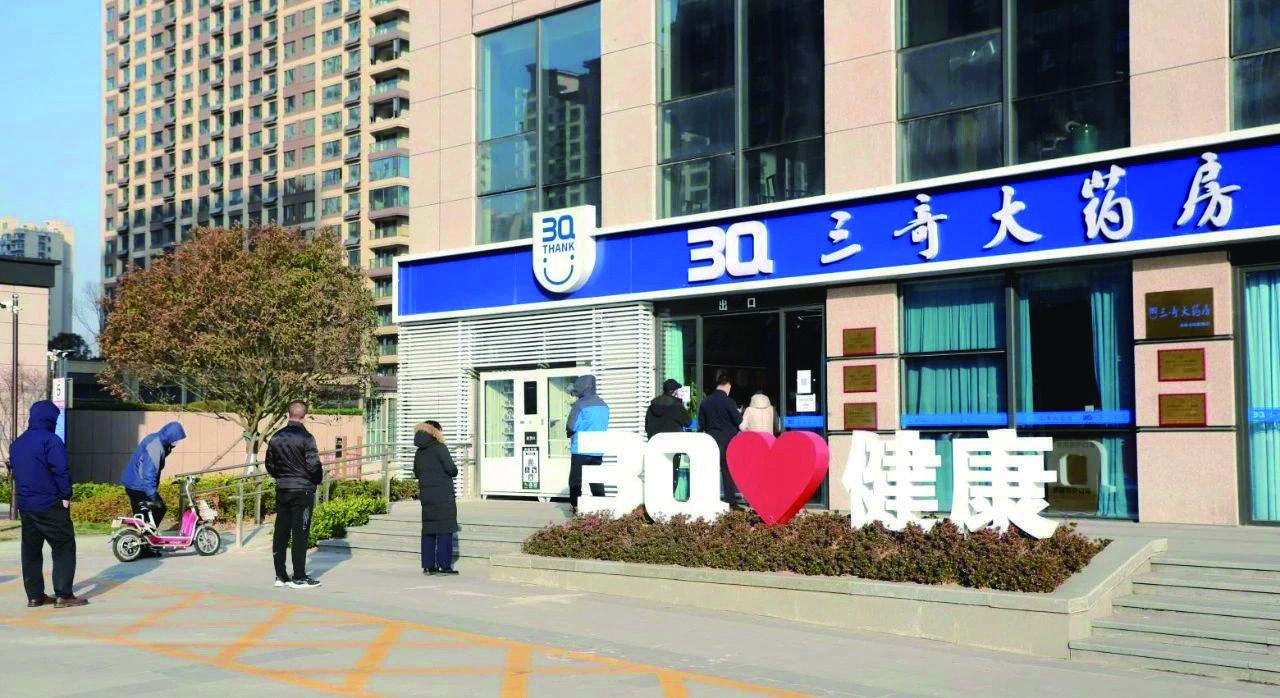 市民在三奇大药房排队领取免费防疫物资